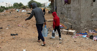 A displaced family carries gallons of water in Tripoli, Libya, REUTERS/Ismail Zitouny