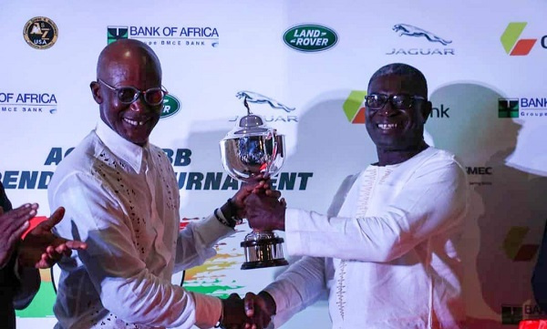 A member of the Ahimota Golf Club receiving the trophy