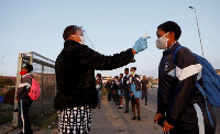 A learner is screened as schools begin to reopen after COVID-19 lockdown in Langa in Cape TOWN