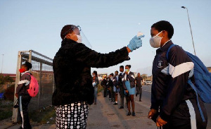 A learner is screened as schools begin to reopen after COVID-19 lockdown in Langa in Cape TOWN