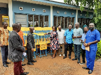 Mrs Frimpong making the presentation to Mr Asamoah, while other group members looked on