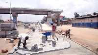 Workers of First Sky paving the front view of the footbridge