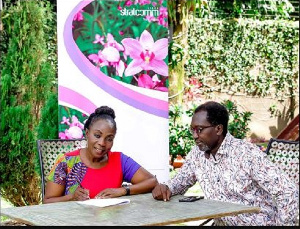 Ms. Esther AN Cobbah signing the MoU in Ghana and with her is Bernard Nana Yaw Tufuor.