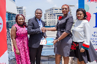 Officials from Glico and Vodafone at the signing