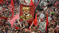 Leverkusen fans celebrate on the pitch after their team beat Werder Bremen 5-0 to win the Bundesliga