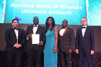 An official of Barclays Bank holding the plaque