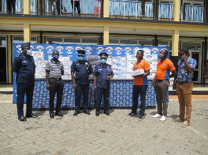 A group photo of staff of Promasidor Ghana and officers of the Greater Accra regional police command