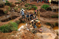 Miners pan sediment for gold at an illegal mine pit in South Kivu province near Bukavu