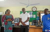 Lawyer Isaac Boamah Nyarko (middle) interacting with the Municipal Director of Education (left)