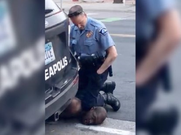 The policeman with his knees to the throat of the deceased African American