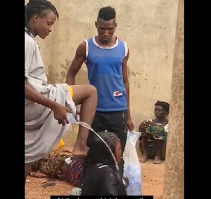 The self-styled witch doctor tormenting one of his victims