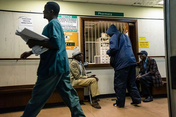 Elderly men wait for medicines at a pharmacy at Parirenyatwa hospital in Harare