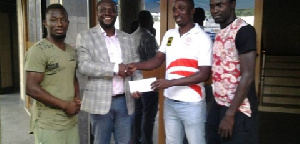 Inter Allies handing an envelope to the Kotoko management