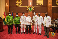 2021 NSMQ champions, Prempeh College presenting the trophy to President Akufo-Addo