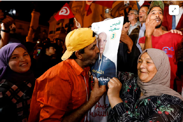 Supporters of Tunisian President Kais Saied, celebrate as exit poll shows Saied won