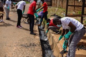 Employees Of Vivo Energy Ghana And United Way Ghana Distilling Gutters During The Clean Up Exercise.