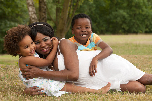 A photograph of a woman and her children