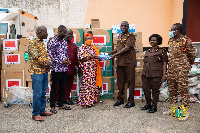 Rep of the Rebecca foundation hands donated items to officials of the Nsawam prisons