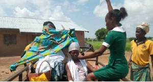 The midwife captured transporting a mother who had just given birth in a tricycle