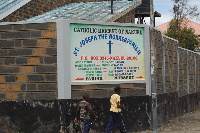 Children walk past St Joseph The Workers Catholic Parish Church in Racetrack Estate in Nakuru Town