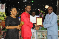 Bishop Kwaku Opoku Sarpong receiving a certificate from Mr. Isaac Rockson