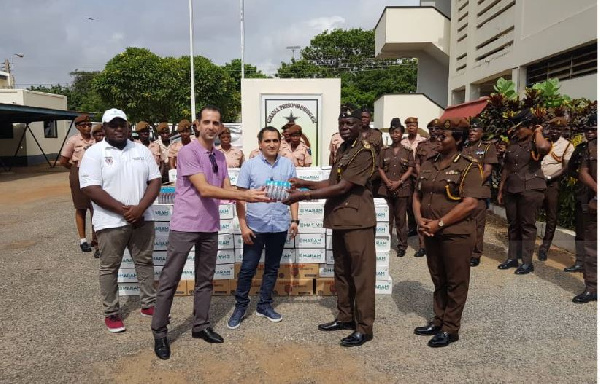 Marketing Executive of Delta Agro Limited, Al-Roz (L) presenting one of the items to Mr Darko Missah