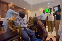 Former President, John Agyekum Kufuor seated and Despite kneeling to greet him