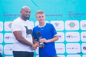 McDan boss Dr Daniel McKorley presents trophy to Mathis Bondaz