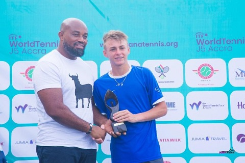 McDan boss Dr Daniel McKorley presents trophy to Mathis Bondaz