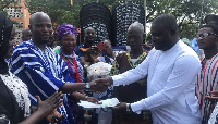 Alhaji Iddrisu presenting the cash to Mohammed Alhassan Ghana, Northern Regional NPP Youth Organizer