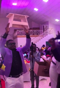 The groom with the kitchen stool presented by his friends