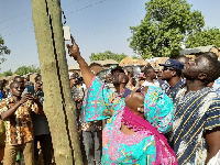 Hajia Alima Mahama putting on the switch to one of the street lights