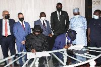 Dr. Sledge Nana Yaw Duodu and Mr. Philip Kwasi Akufo sign the agreement