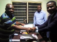 Stevy Daic Ndjala Totolo shaking hands with an official of Swift Institute