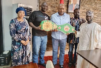 Alhaji Osuman (second left) displaying the titles with former President Mahama