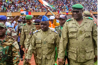 Members of a military council that staged a coup in Niger attend a rally at a stadium in Niamey