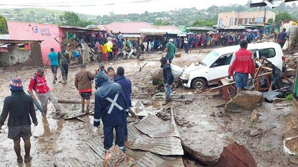 People line a muddy road in this image tweeted by Malawi Red Cross Society on March 13