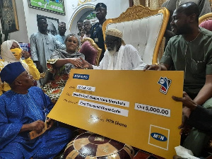 Salihu Abu, and Efua Falconer presenting the dummy cheque to the National Chief Imam