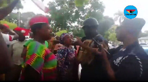 Police officers trying to calm angry members of the NDC