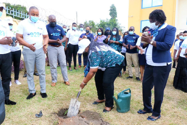 Dr. Lydia Dsane-Selby planting a tree