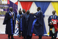 Rev. Prof. Asare-Danso (middle) being robe into the college of Professors at UCC