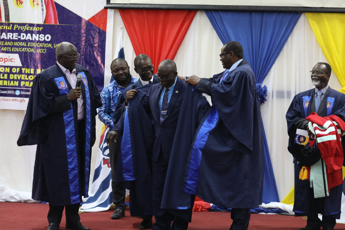 Rev. Prof. Asare-Danso (middle) being robe into the college of Professors at UCC