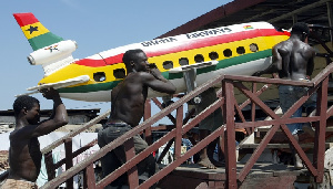 Carpenters carry a coffin shaped in the form of a Ghana Airways aircraft in Accra, January 22, 2004.