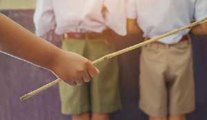 Teacher caning students