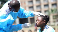 Dr Joseph Kivindu of Lancet Kenya takes swabs from Makolanders Women Football Club player (NMG)