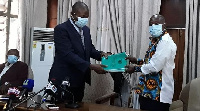 Justice Diawuo (L) submitting the report to Simon Osei Mensah