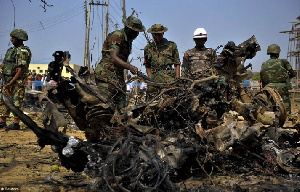 Security forces view the scene of a bomb explosion