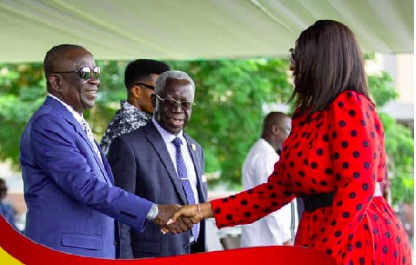 Minister of Nat'l Security in a handshake with Empress Gifty