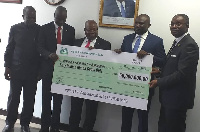 Alhaji Abdul Hannan Alodiba Wahab receiving the cheque of behalf of NAFCO