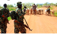 UPDF officers on Moroto – Kotido road in Napak District, Uganda escorting Karamojong herders